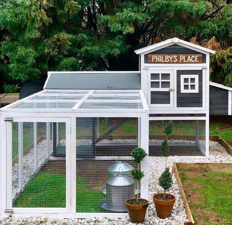 Charcoal Mansion and Run in a customer's backyard with a sign that says Philby's Place