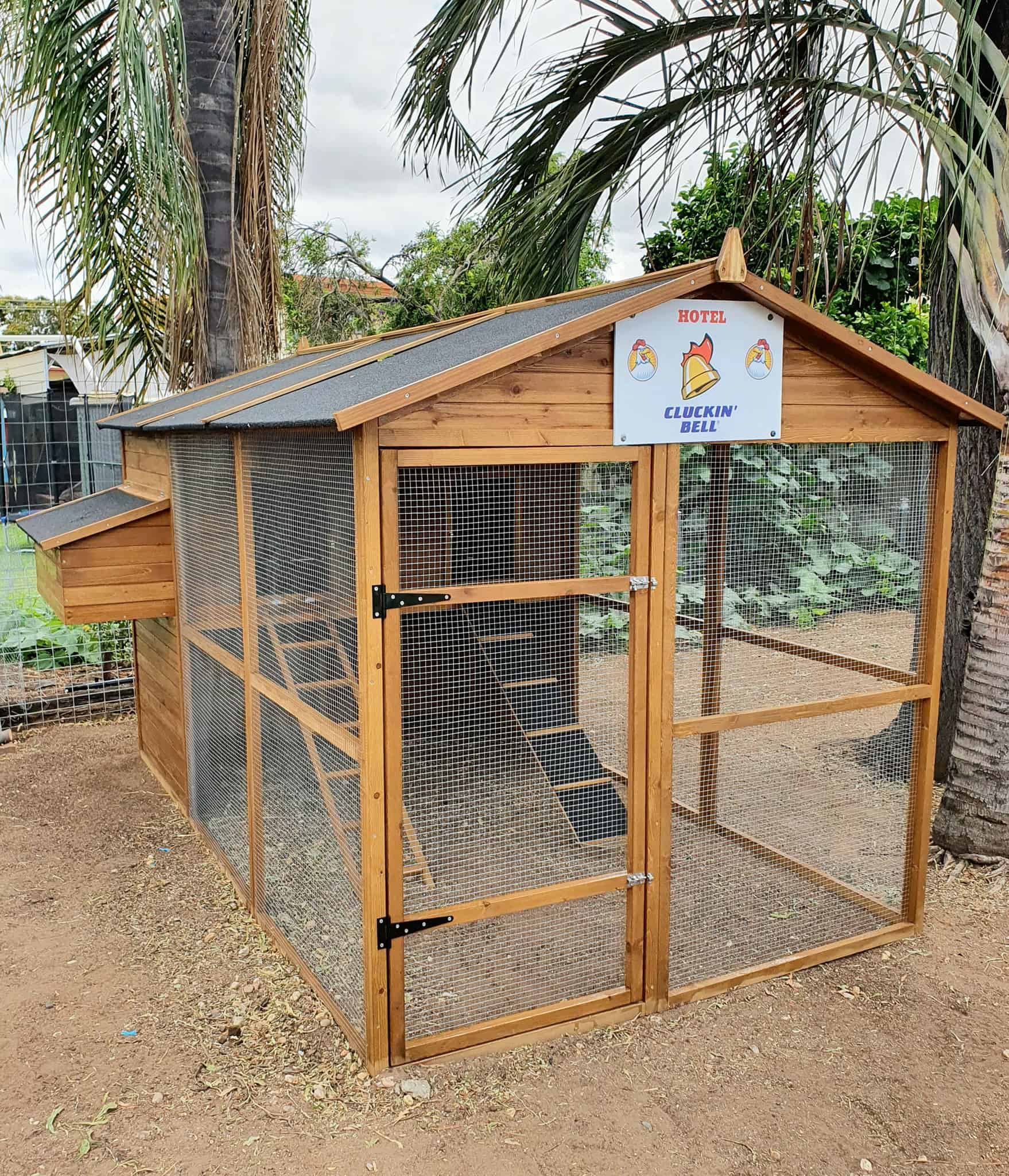 Homestead in a customer's backyard with a sign that says Hotel Cluckin Bell